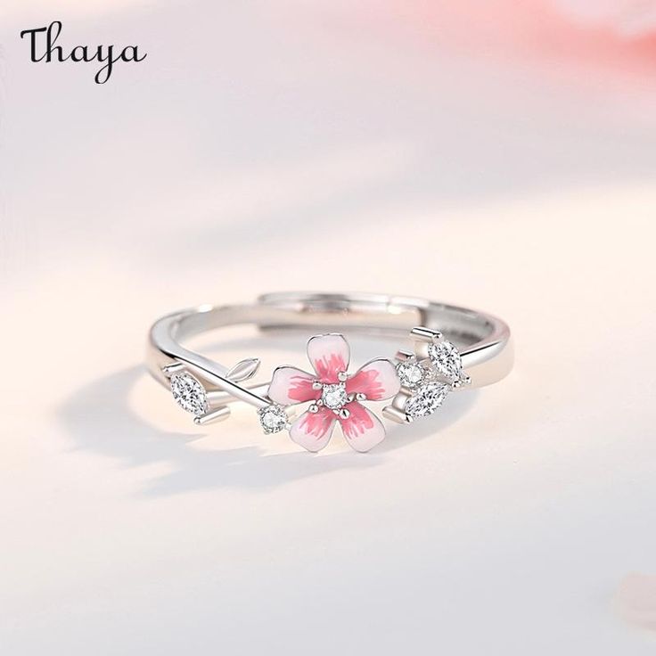 With the Sakura couple rings, celebrate your love in a traditional way. Inspired by the delicate pink blossoms and their symbolism of love and new beginnings, these rings represent a timeless promise between two hearts. Let your love bloom like the beautiful cherry blossoms.   - Brand: Thaya  - Material: S925 silver, synthetic cubic zirconia, enamel.  - Size: The widest part of the men's ring is 5.6 mm, and the widest part of the women's                   ring is 2.6 mm.  - Weight: Male 2.12g Female 1.76g  - Gender: Couple style    Open ring, adjustable, size for reference    Women's rings are suitable for the United States Size: 6-7, the inner diameter is about 16.5-17.3mm  Men's rings are suitable for US Size: 8-9, inner diameter is about 18.1-19mm Flower Promise Rings, Elegant Flower Open Ring For Valentine's Day, Elegant Open Flower Ring For Valentine's Day, Elegant Flower Rings For Valentine's Day, Delicate Pink Flower Ring For Gift, Delicate Pink Flower Ring As Gift, Adjustable Pink Rings For Proposal, Rose Gold Jewelry For Anniversary In Spring, Delicate Pink Flower Ring Gift