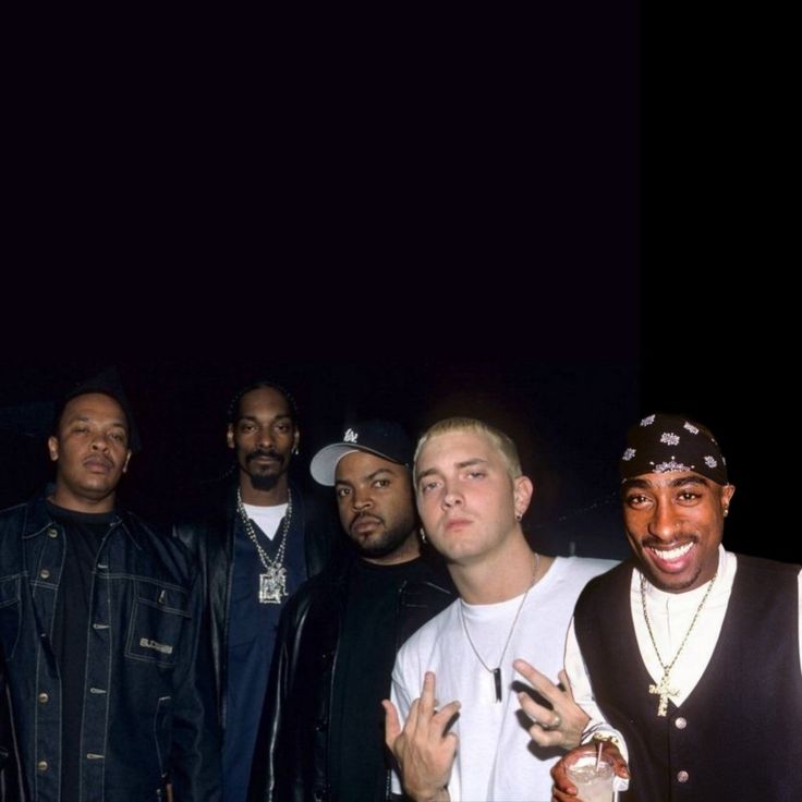 a group of young men standing next to each other in front of a black background