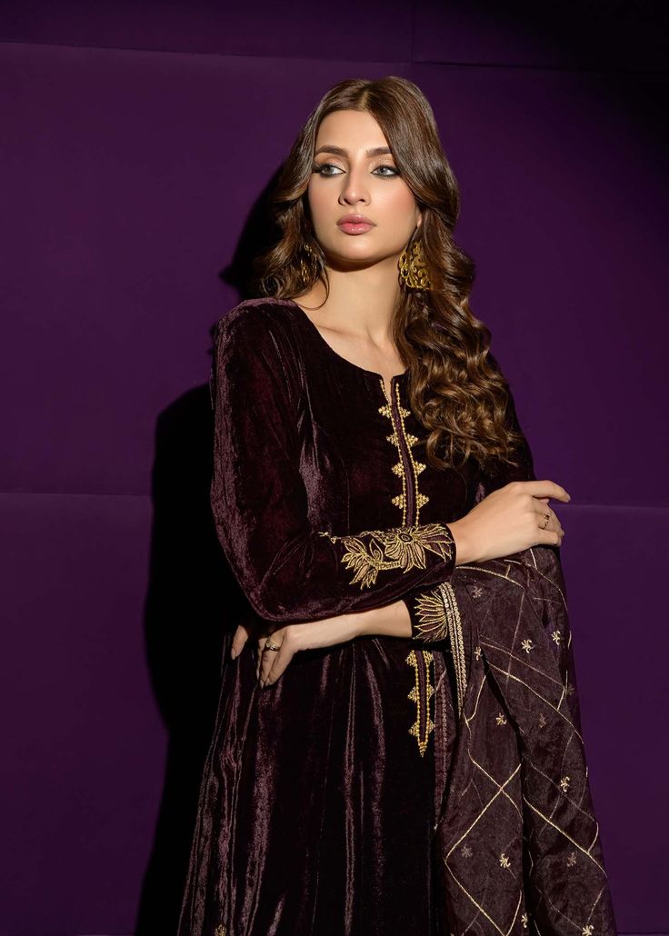 SKU:- 2205 This timeless ensemble showcases a long velvet shirt embellished with intricate cutwork and delicately handcrafted crystals and pearls. Paired elegantly with a resplendent organza featuring opulent golden accents, culminating in an enchantingly celestial allure. Photography color may vary. NOTE: At no additional cost, we offer the option to create all velvet attire using sheesha silk fabric. Elegant Festive Velvet Dress, Designer Gold Velvet Dupatta, Velvet Party Sets For Eid, Velvet Anarkali Party Sets, Designer Embroidered Velvet Dress, Velvet Dress With Traditional Drape For Designer Wear, Velvet Sets With Intricate Embroidery For Eid, Elegant Velvet Dress For Eid, Velvet Party Dress With Resham Embroidery