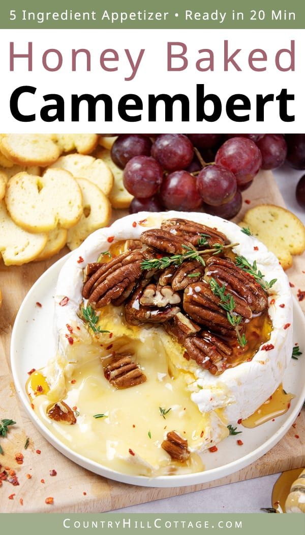 a white plate topped with mashed potatoes covered in cheese and pecans next to grapes