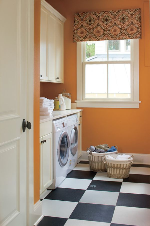 an orange and black checkered floor in a laundry room with washer and dryer