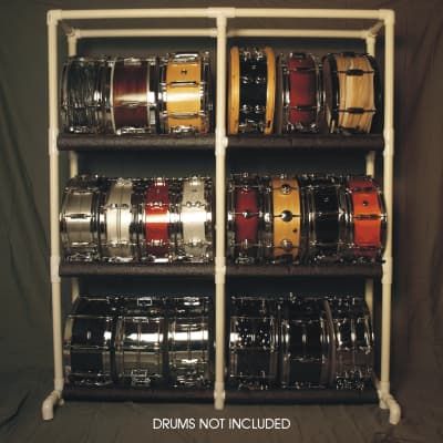 the drum rack is full of drums and other musical instruments that are stacked on top of each other