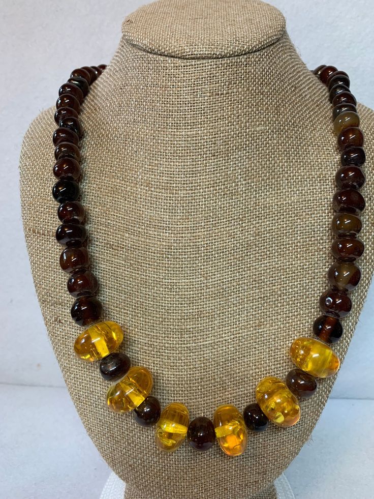 Stunning amber and glass bead necklace, 6 amber pieces surrounded by round, brown, glass beads.  26 inches long with brass lobster claw clasp. Adjustable Amber Beaded Necklace With Large Beads, Amber Beaded Czech Glass Necklaces, Amber Beaded Necklace With Czech Glass, Brown Polished Beads Round Necklace, Brown Beaded Necklace With Oval Beads, Brown Beaded Necklaces With Oval Beads, Brown Polished Bead Round Necklaces, Handmade Baltic Amber Necklace In Brown, Adjustable Round Brown Beaded Necklace