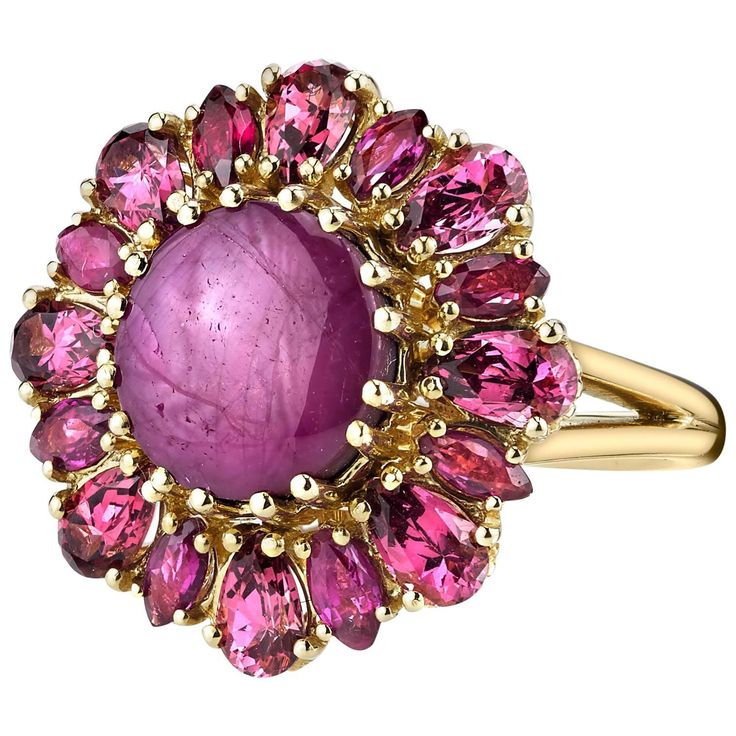 This starburst cocktail ring features a strawberry milkshake-color star ruby, artfully framed by coordinating pear shaped, pink rose colored rhodolite garnets and marquise shaped rubies. Handmade in 18k yellow gold in our signature retro-style ring by our Master Jewelers in Los Angeles. One-of-a-kind and totally fun! Gems in yummy berry colors make a great conversation piece! Ring size 7 Complimentary sizing as needed Star ruby, 9.80 x 9.13 x 5.17mm, 5.83 carats Rhodolite garnets, 2.05 carat tot Starburst Cocktail, Yellow Gold Cocktail Ring, Gothic Ring, Antique Engagement Rings Vintage, Gold Starburst, Vintage Cocktail Ring, Milk Shakes, Retro Ring, Gothic Rings