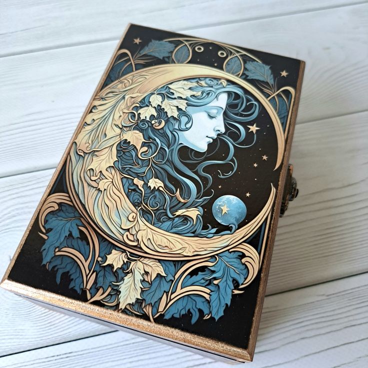 an intricately designed box with a woman's face on it and stars in the sky