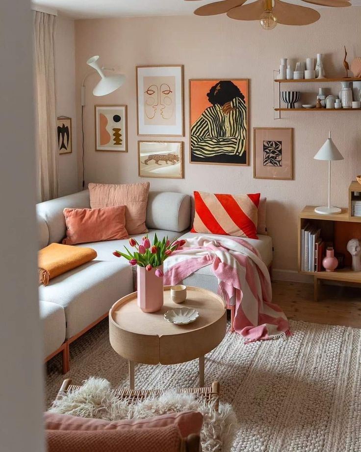 a living room filled with furniture and pictures on the wall