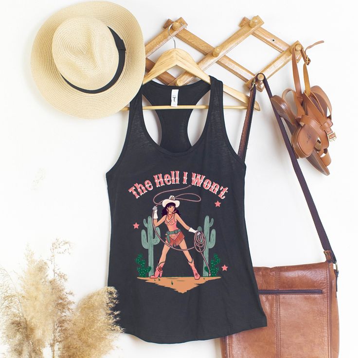 The Hell I Won't Tank Top; SLIM FIT Racerback Tank ★ P R O D U C T * I N F O ★ * all items are made to order ★ P R O D U C T * S P E C S ★ * Women's Ideal Racerback Tank Super Comfy * 3.9 oz., 60/40 combed ring spun cotton/polyester, 30 singles * Fabric laundered * Self-fabric binding * Curved hem * Side seams * Tearaway label --> Slim fit --> Runs smaller than usual --> Please view the size chart photo, in the photos section of the listing. - Colors may differ slightly in person than on a monit Western Cotton Tops For Country Festivals, Fitted Distressed Cotton Tank Top, Distressed Fitted Cotton Tank Top, Spring Band Merch Cotton Tank Top, Spring Cotton Tank Top With Band Merch, Western Style Fitted Sleeveless Tank Top, Black Western Tops For Summer, Fitted Sleeveless Western Tank Top, Fitted Western Style Sleeveless Tank Top