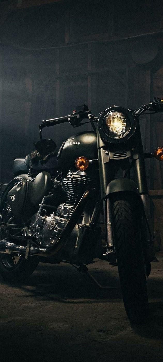 a black motorcycle parked in a dark room