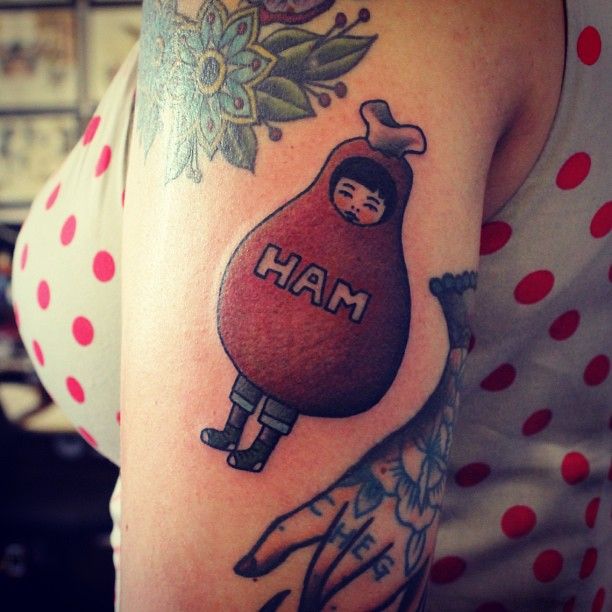 a woman with a tattoo on her arm has a hand holding a bag that says ham