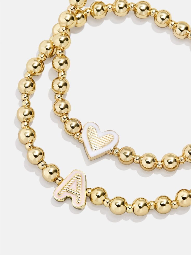 Give your mini the best of both worlds when you scoop up this two-in-one, super stackable bracelet set. The Initial & Heart Kids' Pisa Bracelet Set will feature the initial of your choosing crafted in vibrant enamel and flanked by gold ball beads. We paired each initial with a white enamel heart bracelet, ensuring your little's bracelet stack will be extra meaningful. READY TO GIFT: This item comes pre-packaged in a beautiful box. Please note: intended for children 3+ Heart Kids, Stackable Bracelets, Heart For Kids, Beaded Stretch Bracelet, Heart Bracelet, White Enamel, Bracelet Stack, Bracelet Sizes, Gold Beads