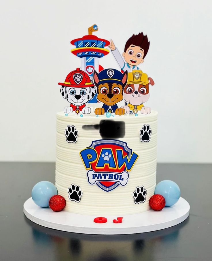 a birthday cake with paw patrol decorations on it