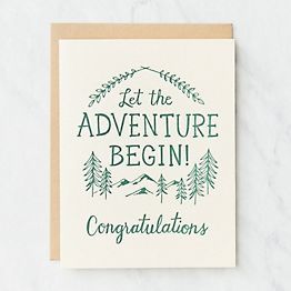 a card with the words let the adventure begin congratulations written in green ink on it