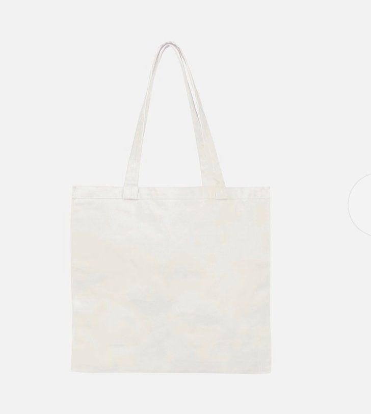 a white tote bag sitting on top of a table