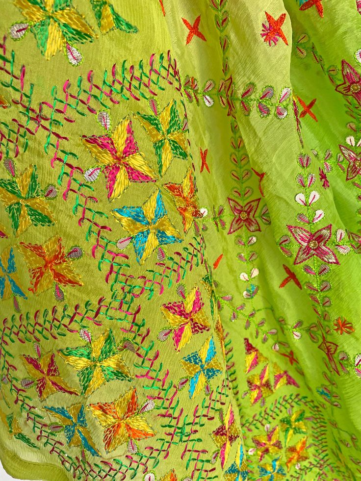 This elegant traditional Green Bridal Phulkari Dupatta is expertly crafted from Pure Chinon Silk, with Gotta Patti and phulkari hand embroidery all over. The perfect choice for weddings, sangeet, jaago, and chunni ceremonies. Material: Pure silk chinon Work: Silk thread phulkari handwork, all over gotta patti work Pattern: Floral Size: Full Size 2.5 meters Dispatched in 1-3 business days Product Note:​ This is a handcrafted product from artisans and producer groups and due to the nature of the p Green Salwar Kameez With Chikankari For Navratri, Green Kurta With Dupatta For Festival, Traditional Pista Green Salwar Kameez For Navratri, Traditional Pista Green Chanderi Salwar Kameez, Traditional Chanderi Salwar Kameez In Pista Green, Bohemian Green Salwar Kameez With Cutdana, Embroidered Pista Green Chanderi Traditional Wear, Pista Green Embroidered Chanderi Traditional Wear, Green Chikankari Embroidery Dupatta For Diwali