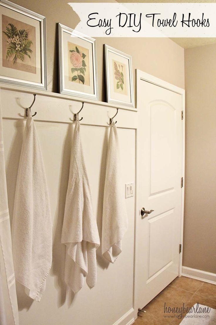 towels hanging on hooks in front of a white door with the words easy diy towel hooks