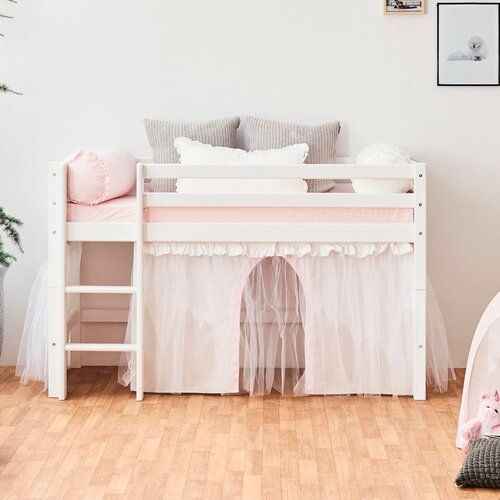 a white bunk bed sitting on top of a hard wood floor