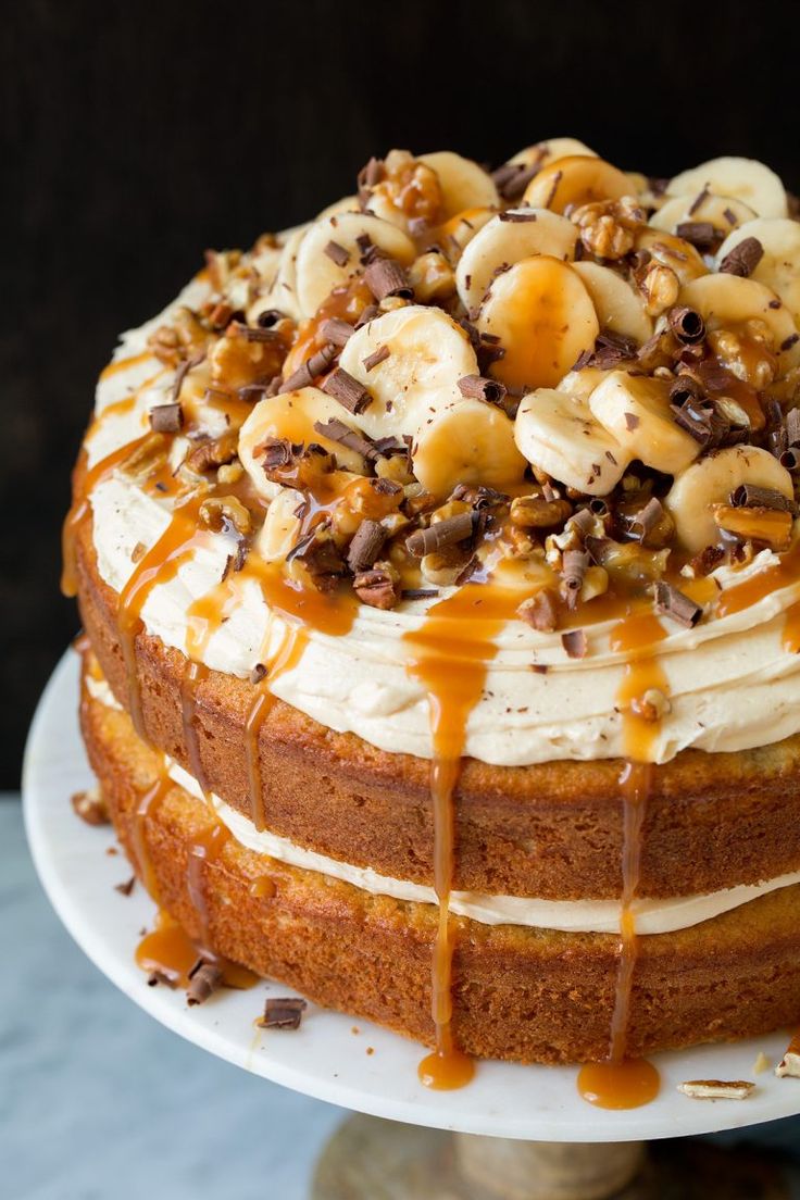 a cake with bananas, nuts and caramel drizzled on the top