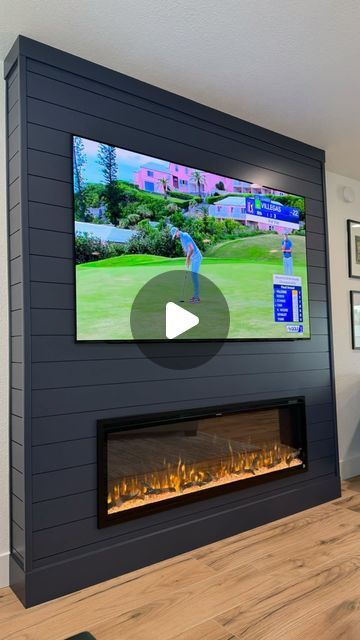 a large television mounted on the wall above a fireplace