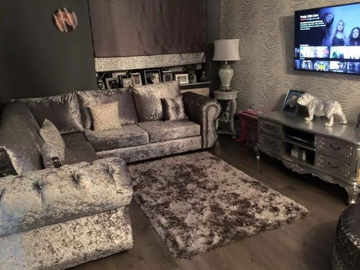 a living room filled with furniture and a flat screen tv mounted to the side of a wall