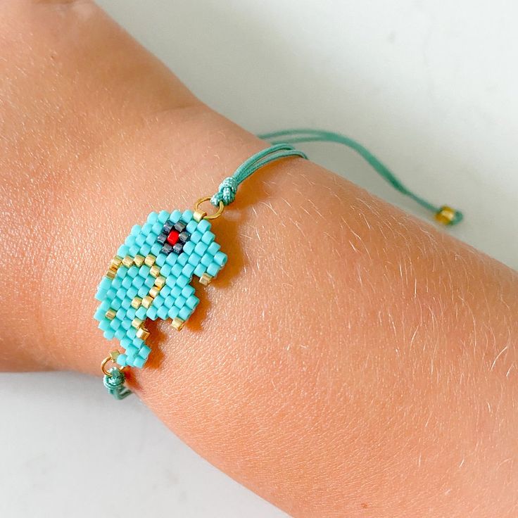 Elephant Bead Bracelet Adjustable Cord Beaded Bracelets As Gift, Handmade Friendship Bracelets With Round Beads, Handmade Adjustable Friendship Bracelets With Round Beads, Adjustable Turquoise Beaded Bracelets Gift, Casual Blue Beaded Bracelets, Adjustable Tiny Bead Friendship Bracelets As Gift, Green Beaded Bracelets With Adjustable Length, Adjustable Round Beads For Friendship, Casual Adjustable Beaded Bracelets With Sliding Knot