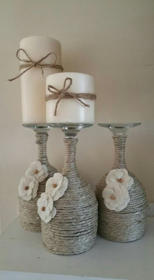 three white candles sitting on top of a shelf