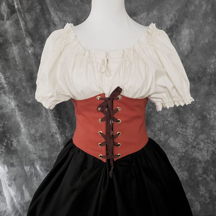 "This waist cincher is made in 100% Cotton in BURNT ORANGE. The perfect compliment to your Witch, Pirate, Renaissance, Medieval or other fantasy cosplay costume. It is lined with cotton duck and it has spring steel boning in the front for stability and to reinforce the grommets (this boning has some flex to it so it will move with you some as well). A very comfortable, yet sturdy piece.   Measure your waist as the smallest point (typically just about the belly button) and choose from the following sizes:  X-SMALL: Waist 25.5 - 28 inches (64 - 71 cm) SMALL: Waist 28 - 31 inches (71 - 79 cm)  MEDIUM: Waist: 30 - 33 inches (76 - 84 cm) LARGE: Waist: 32 - 35 inches (81 - 89 cm) X-LARGE: Waist: 34 - 37 inches (86.5 - 94 cm)  XXLARGE: Waist 36 - 39 inches (91.5 - 99 cm) ✿✿THIS PIECE IS MADE TO O Overbust Corset Belt For Halloween Cosplay, Fitted Gothic Costume For Medieval Festivals, Fitted Costumes For Larp And Medieval Festivals, Steampunk Corset Belt For Halloween Costume Party, Steampunk Corset Belt For Larp And Halloween, Steampunk Corset For Larp And Cosplay Events, Halloween Costume Underbust Corset Belt, Underbust Corset Belt For Halloween Costume, Fantasy Costume Corset Belt With Corset Back