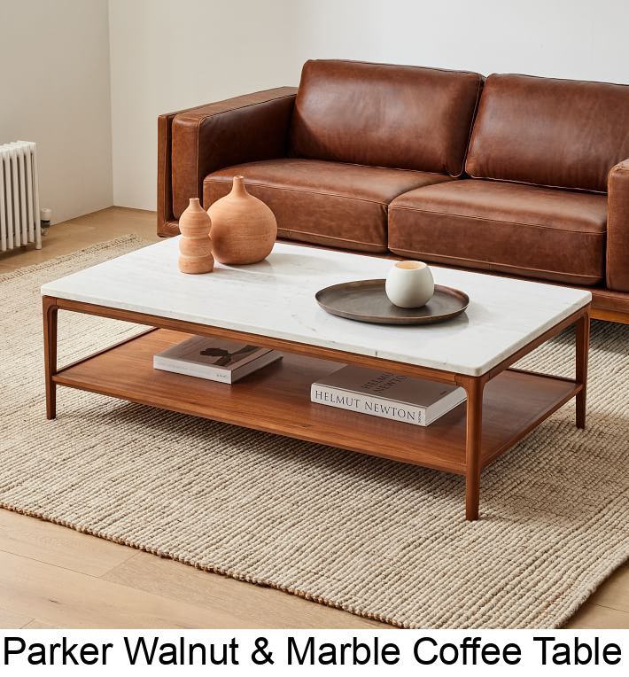 a living room with leather couches and marble coffee table in front of the sofa