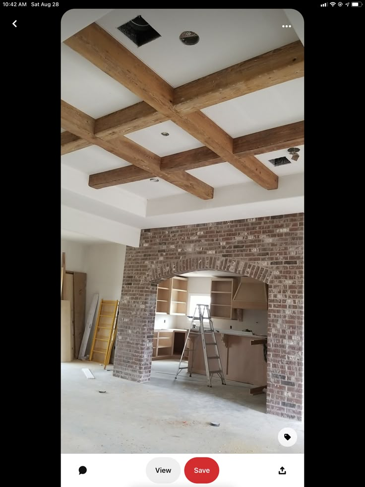 an image of a room being remodeled with wood beams and exposed ceilinging in progress