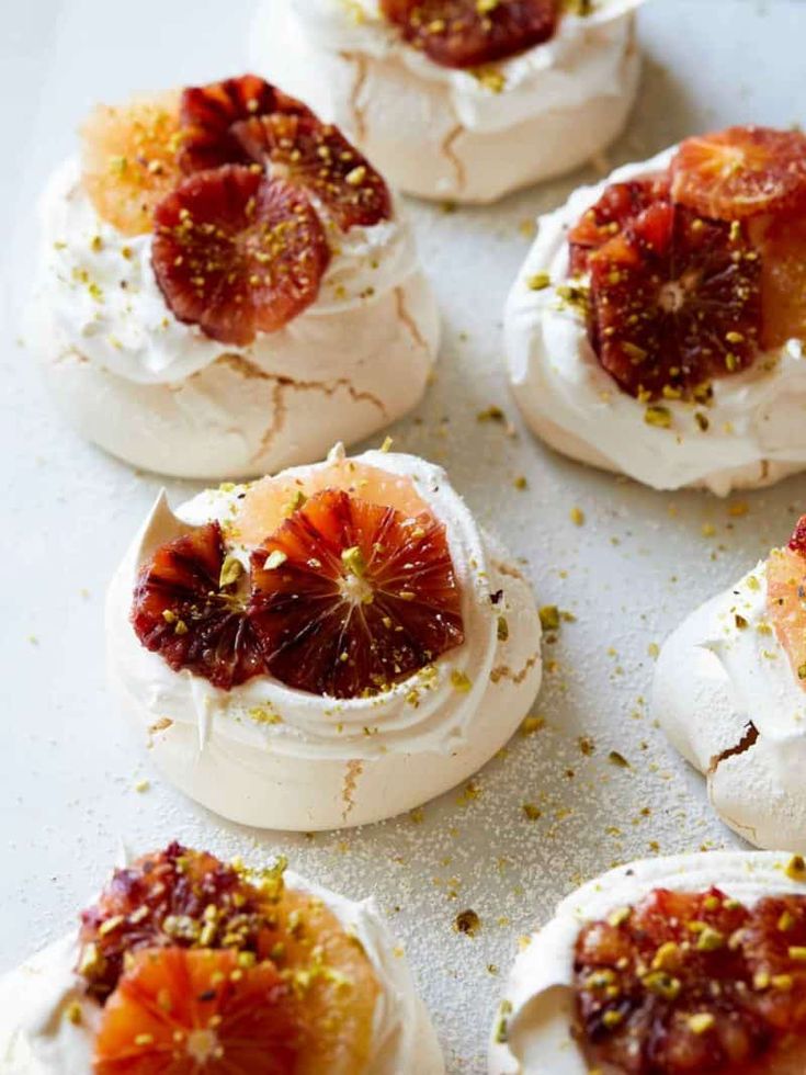 small appetizers are arranged on a white surface