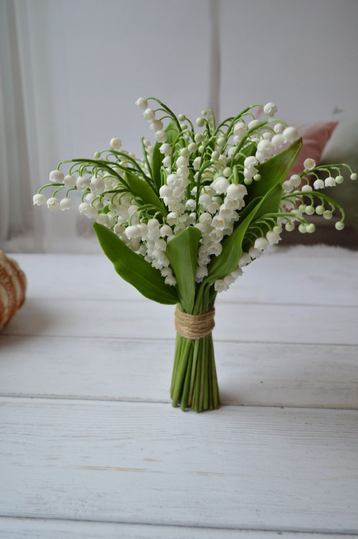 a bouquet of white flowers sitting on top of a table