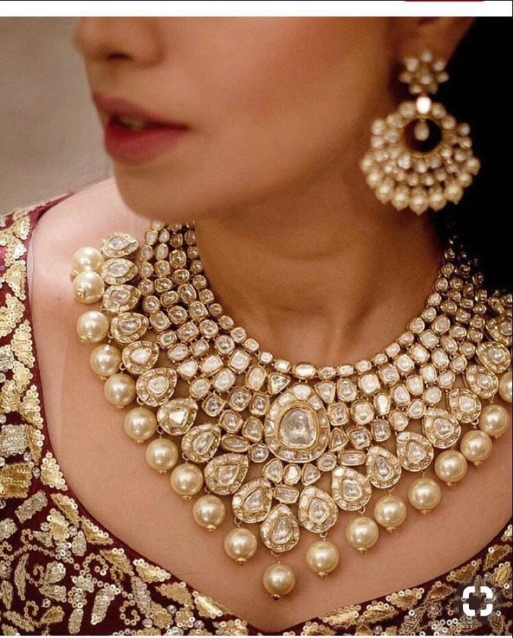 a woman wearing an elaborate necklace and earrings