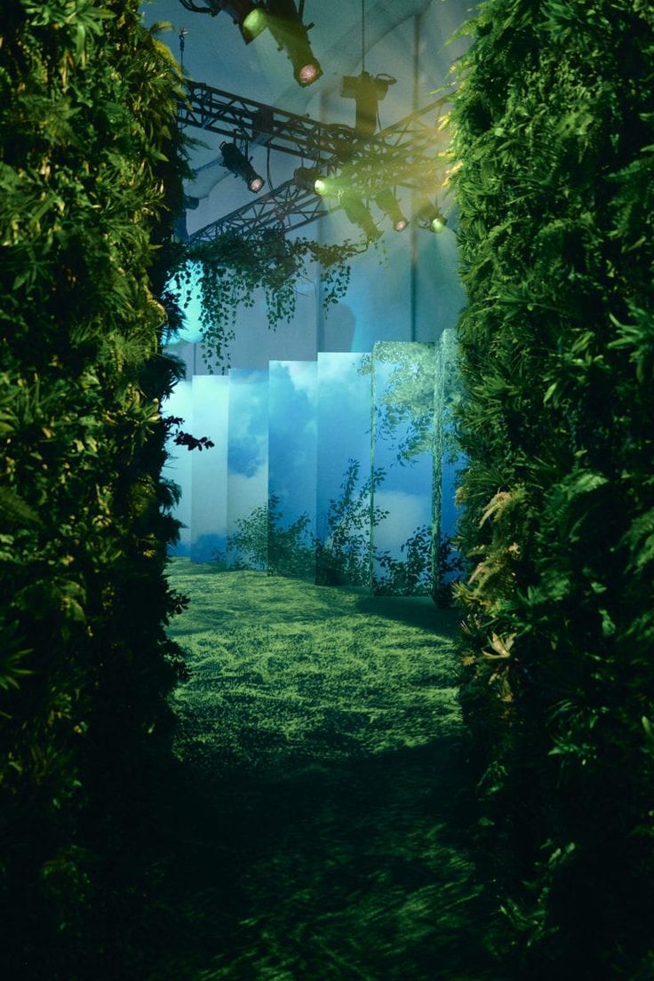 an image of the inside of a building that looks like it is surrounded by greenery