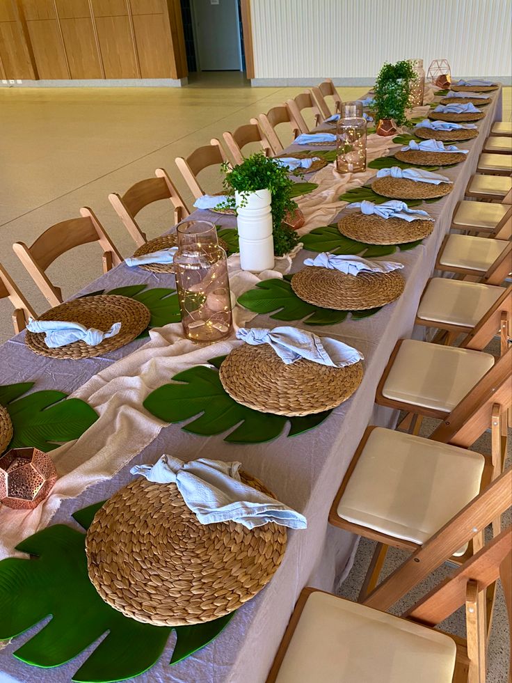 a long table is set up with plates and napkins for guests to sit at