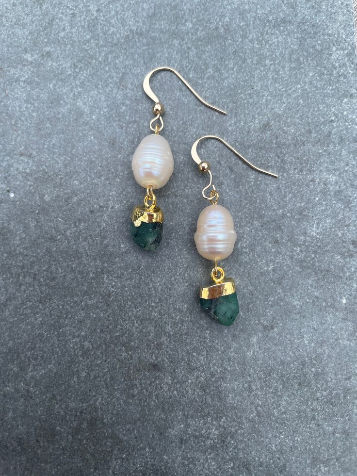 Free UK delivery. Free worldwide delivery with orders over £75.  Pale cream fresh water pearls with raw Emerald stone. Rolled gold piercers earwires. Length of earrings approx 1.5 inches (4cm). Raw Emerald Earrings, Gold Pearl Earrings With Natural Stones, Gold Piercings, Earring Inspo, Cream Fresh, Gemstone Wedding, Raw Emerald, Fresh Water Pearls, Silver Choker