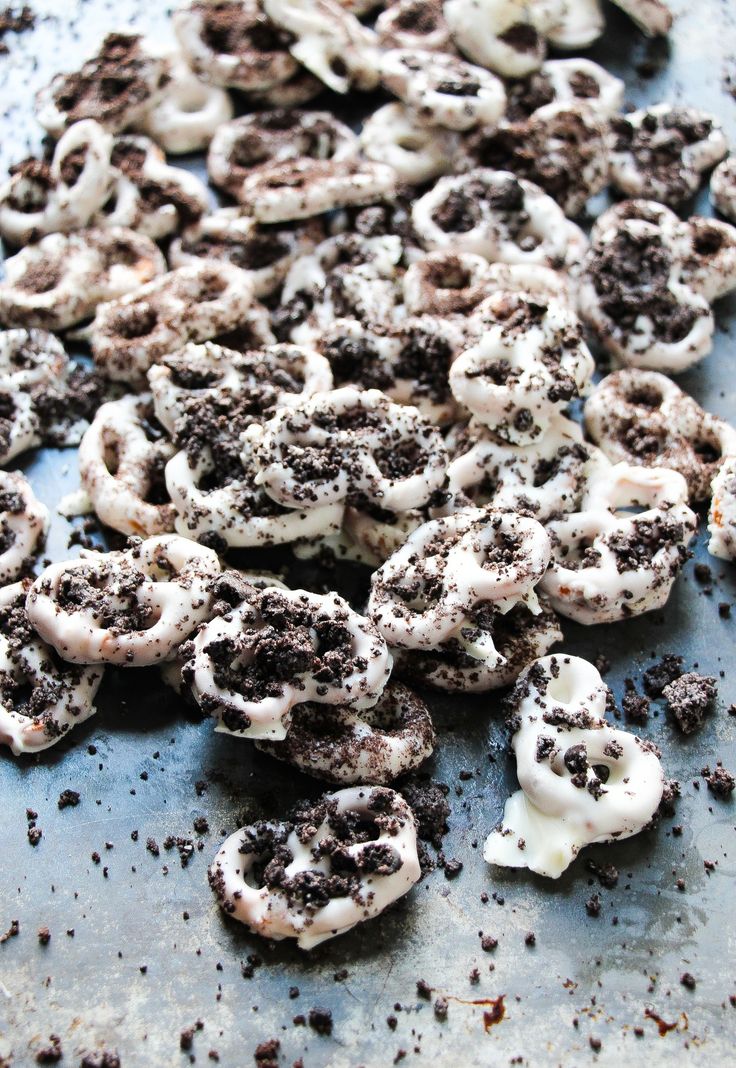 there are many cookies and creams on the baking sheet with cookie crumbs all over them