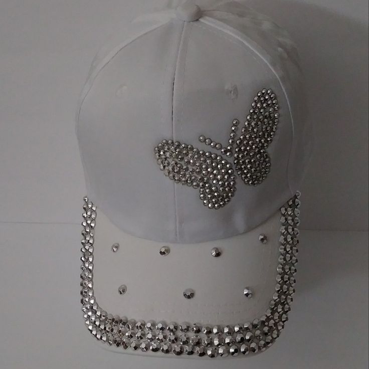 Kendall & James White Butterfly Bling Hat This Is An Outstanding Addition For Any Wardrobe. Get This Deal For Yourself Or As A Perfect Gift. Features: Adjustable Pony Tail Hole Lightweight Care Instructions: Spot Clean Only Baseball Cap Decorating Ideas, White Snapback Baseball Cap For Spring, Trendy White Baseball Cap For The Beach, White Snapback Hat For Party, Trendy White Baseball Cap For Beach, White Spring Cap, White Adjustable Baseball Cap For Spring, White Visor Baseball Cap For Summer, White Baseball Cap For Summer