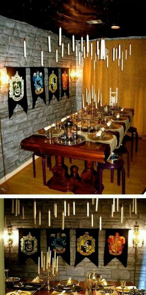 a long table with many glasses on it in front of a wall decorated with hogwarts banners