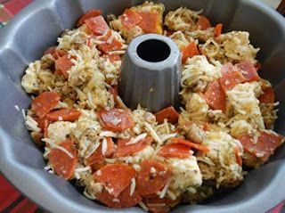 a food processor filled with lots of toppings on top of a red and white table cloth