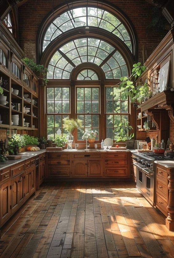 an old fashioned kitchen with wooden floors and arched window above the sink, potted plants are on the counter