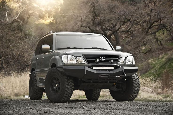 an suv parked on the side of a dirt road