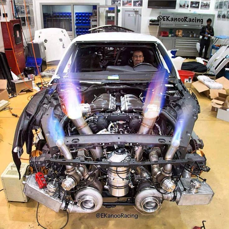 a car engine is being worked on in a garage