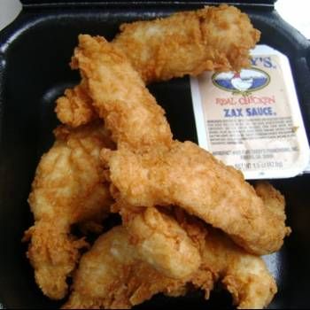 some fried food in a black container on a table