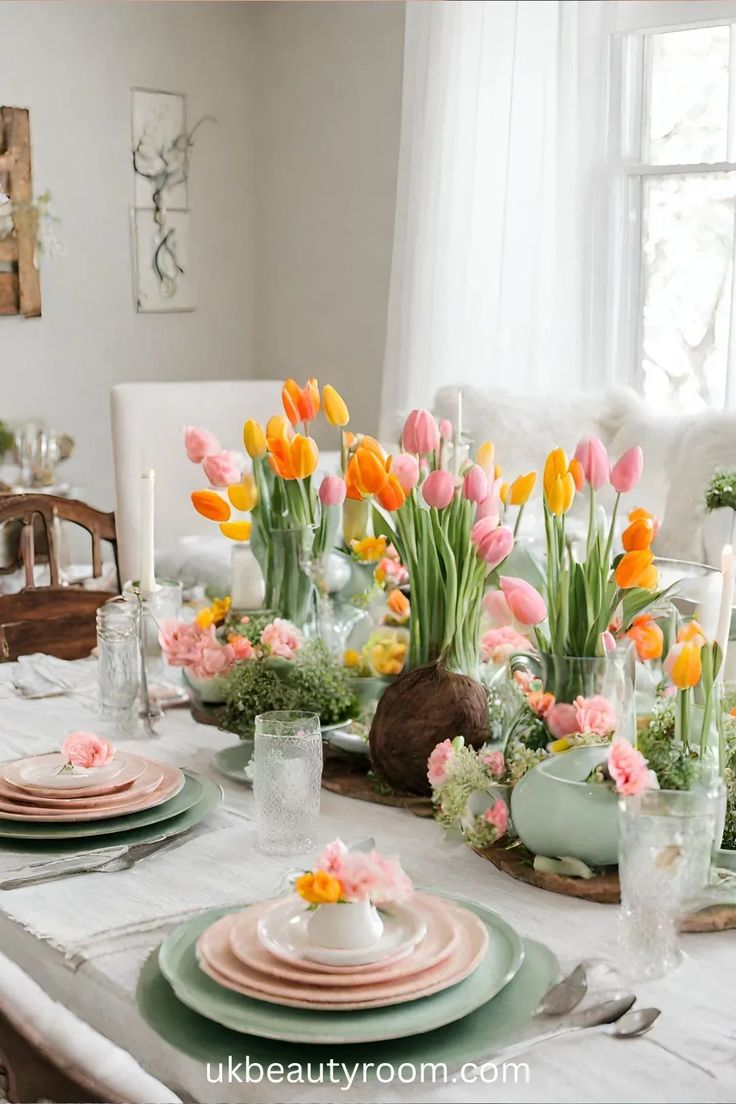 a dining room table set for easter with tulips and other flowers in vases