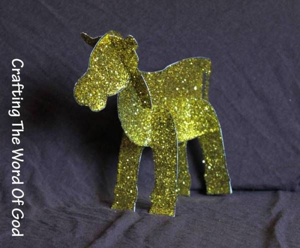 a small yellow horse made out of glitter