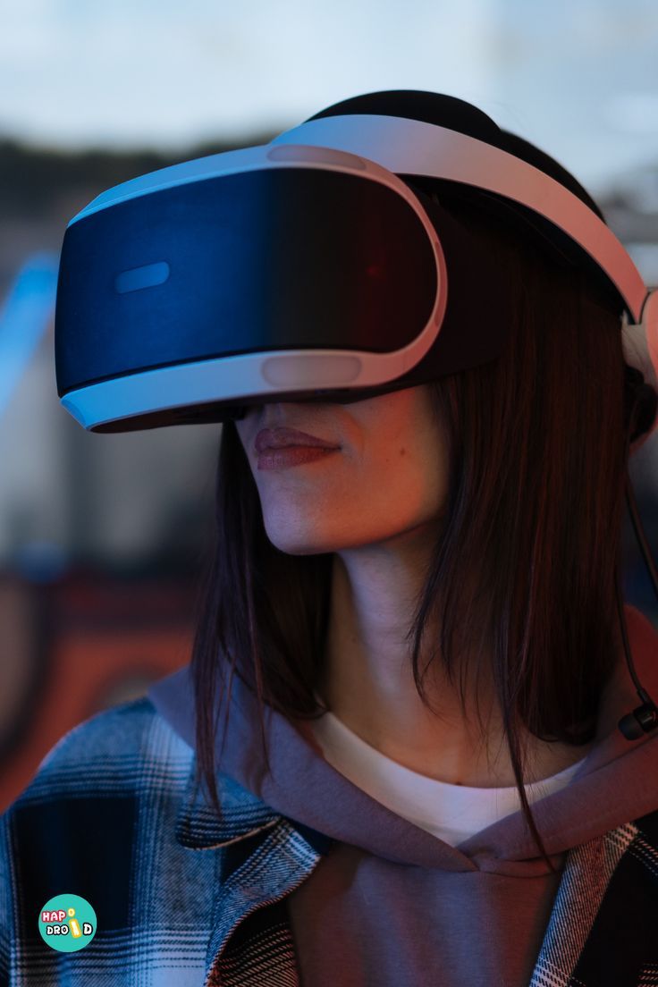 a woman wearing a virtual reality headset in front of her face and looking at the camera