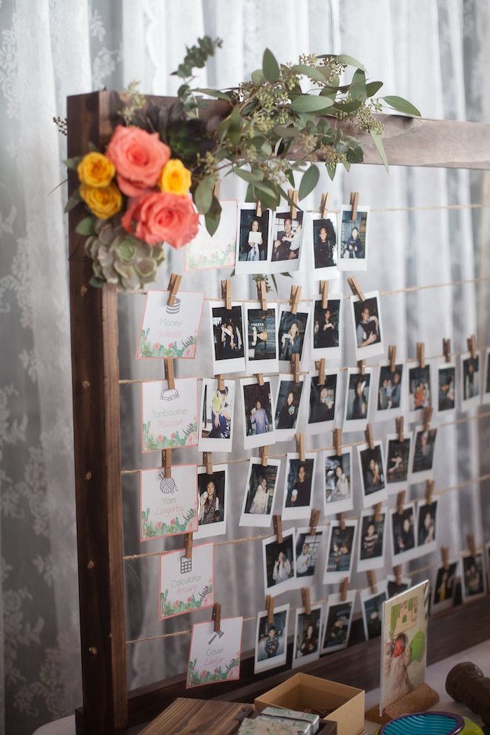 a wooden frame with pictures and flowers hanging from it