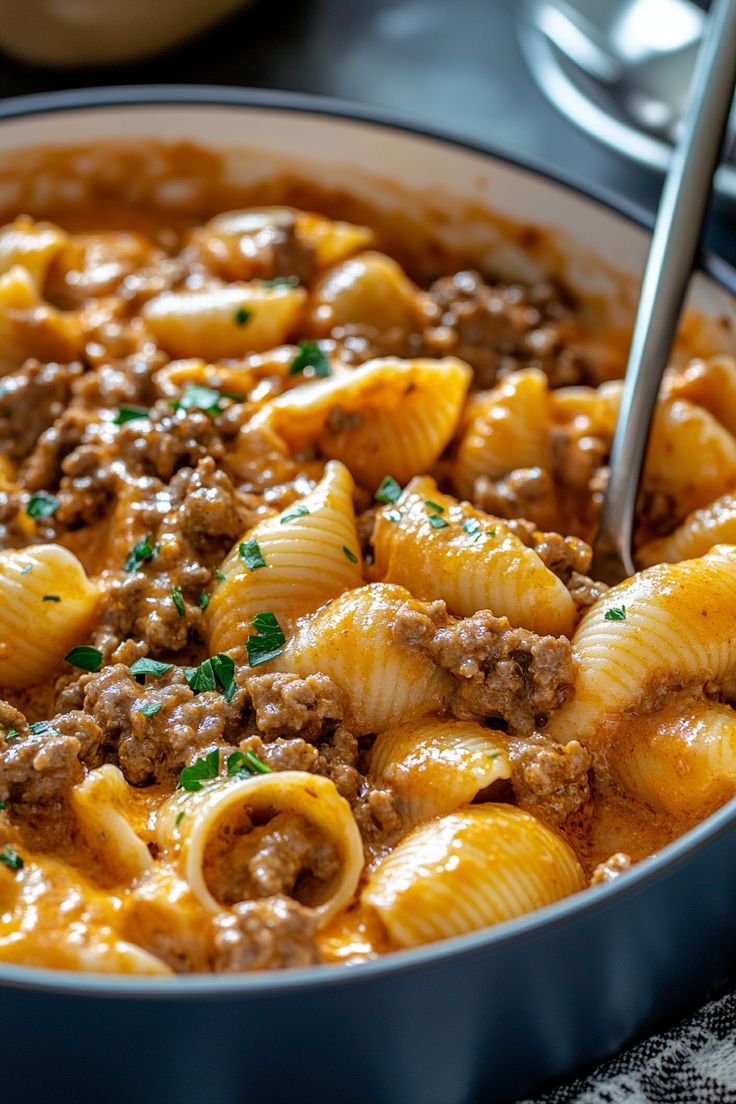 a skillet filled with pasta and ground beef in sauce, ready to be eaten