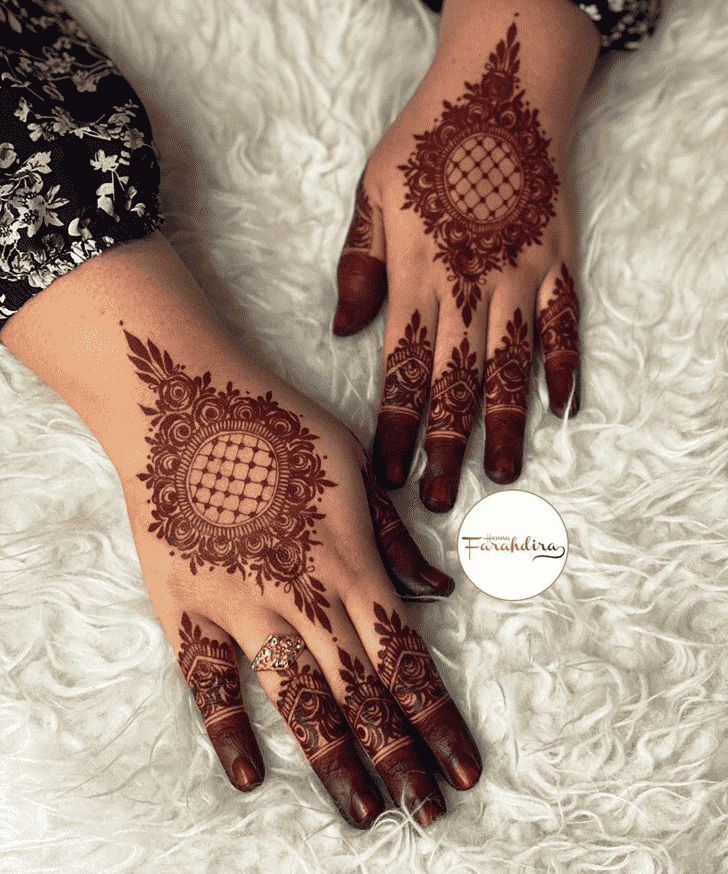 two hands with henna designs on them