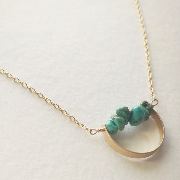 Description A line of semi-precious pebbles create the horizon of this gemstone necklace. Brass curved bar with 14K gold dipped chain. Choose your length. Spring ring closure. You choice of clear quartz, unakite, aquamarine or turquoise semi-precious stone. WHAT IS GOLD DIPPED? Gold dipped is the best alternative to solid gold, and that's why we use gold dipped metals in our jewelry designs. Our gold dipped jewelry components have 150-200 layers of pure solid gold over a base metal. Unlike gold- Minimalist Turquoise Wire Wrapped Jewelry, Everyday Turquoise Jewelry With Natural Stones, Everyday Turquoise Brass Jewelry, Everyday Turquoise Wire Wrapped Jewelry, Minimalist Turquoise Gemstone Necklace, Minimalist Brass Necklace With Gemstone, Everyday Brass Jewelry With Natural Stones, Minimalist Brass Gemstone Necklace, Minimalist Turquoise Jewelry With Natural Stones