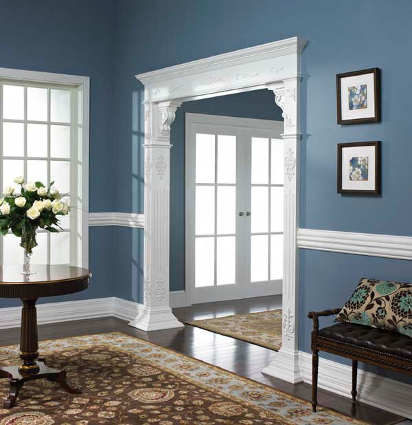 a living room with blue walls and white trim